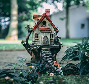 Model house in a garden. Links to Gifts of Real Estate