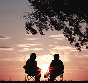 Two people sitting outside. Links to Gifts from Retirement Plans